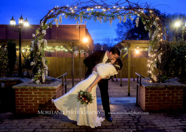 Groom dipping his bride for a kiss, Mike Moreland, Moreland Photography, wedding photography, Atlanta wedding photography, detailed wedding photography, lifestyle wedding photography, Atlanta wedding photographer, Conservatory at Waterstone, New Years, New Years Wedding, 2017 Wedding, Kiss, Groom and bride, 