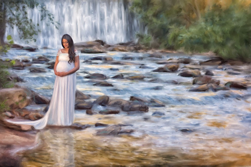 Painted canvas of pregnant woman in front of waterfall